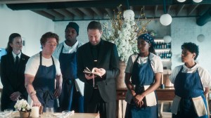 THE BEAR Season 4 stars (l-r) Sarah Ramos as Jessica , Jeremy Allen White as Carmy, Lionel Boyce as Marcus, Ebon Moss-Bachrach as Richie, Ayo Edebiri as Sydney, Liza Colón-Zayas as Tina, shown here going over the menu in the restaurant dining room